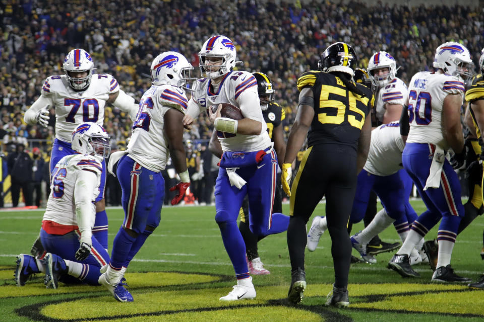 Buffalo Bills quarterback Josh Allen, center, scores on a 1-yard run during the first half of an NFL football game against the Pittsburgh Steelers in Pittsburgh, Sunday, Dec. 15, 2019. (AP Photo/Don Wright)