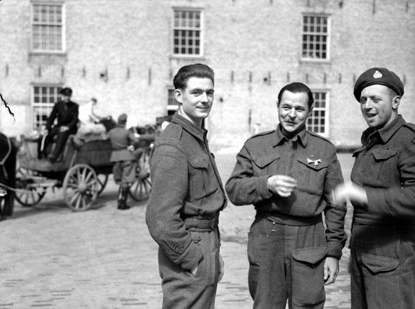 <p>Photographer: Grant, Donald I. Location: Leeuwarden, Netherlands. Description: (L-R) Private P.E. Harter of the 1st Battalion, the Canadian Scottish Regiment; Private L.A. Hutchenson of The Essex Scottish Regiment; Corporal P.W. Tedball of The Algonquin Regime. Date: April 16, 1945. Credit: Library and Archives Canada</p> 