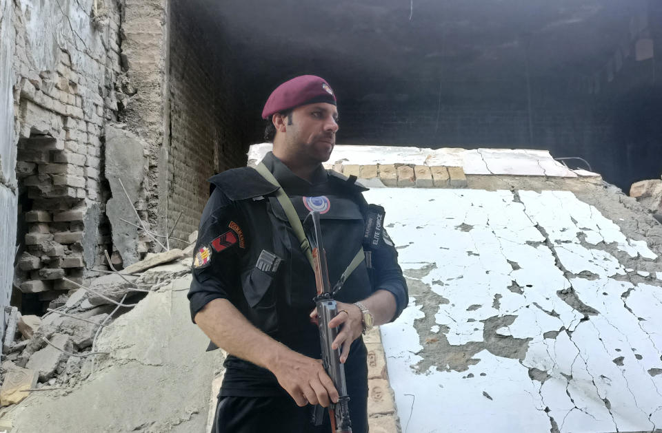 A security member stands guard inside a damages police compound after a suicide bomber attack in the Bara Khyber Pakhtunkhwa, Pakistan, Thursday, July 20, 2023. Suicide bombers attacked a sprawling compound housing a police station and government offices in northwest Pakistan on Thursday, killing at least two police officers and wounding over a dozen other people, police and rescue officials said. (AP Photo/Qazi Rauf)