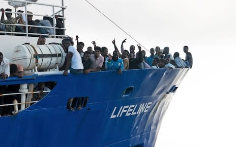 Migrants wave from aboard the Lifeline ship operated by the German NGO Mission Lifeline. Italy's interior minister says Malta should accept it because the ship is now in Maltese waters - Credit: Mission Lifeline