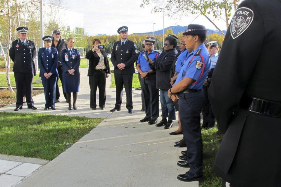 Law enforcement representatives from Papua New Guinea sing a song during a police remembrance ceremony Friday, Sept. 27, 2019, in Anchorage, Alaska. The singers were among delegates attending an international police convention who observed their region's fallen officers in the quickly planned ceremony with their Alaska counterparts. (AP Photo/Rachel D'Oro)