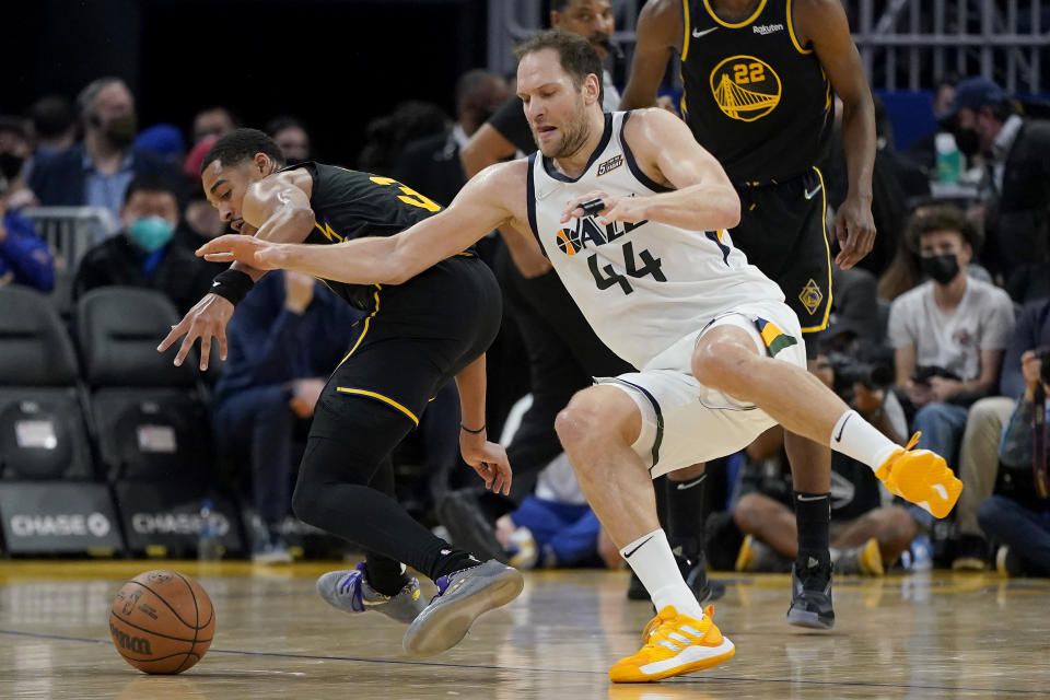 Utah Jazz forward Bojan Bogdanovic (44) loses the ball after being fouled by Golden State Warriors guard Jordan Poole, left, during the first half of an NBA basketball game in San Francisco, Sunday, Jan. 23, 2022. (AP Photo/Jeff Chiu)