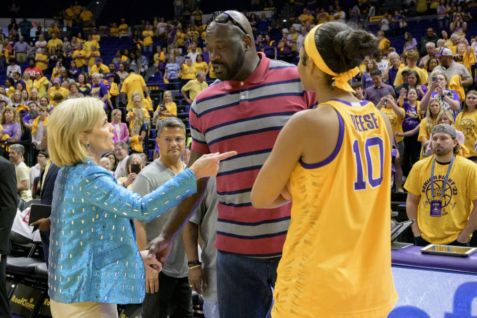 LSU head coach Kim Mulkey, left, and LSU forward Angel Reese, right, talk with former LSU and NBA center Shaquille "Shaq" O'Neal at the end of an NCAA college basketball game between LSU and Mississippi State, Sunday, Feb. 26, 2023, in Baton Rouge, La. (AP Photo/Matthew Hinton)