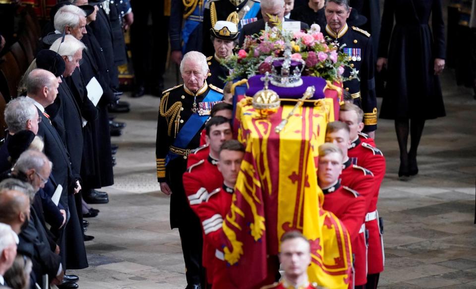 The coffin of Queen Elizabeth II is carried out of Westminster Abbey on Monday (via Reuters)