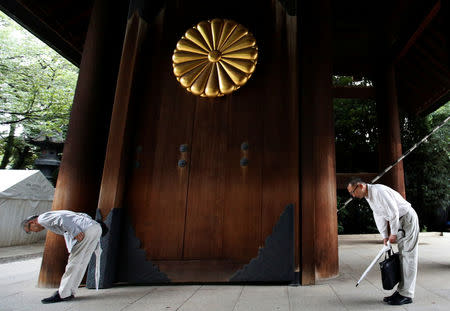 Visitors bow while paying tribute to the war dead at Yasukuni Shrine in Tokyo, Japan August 15, 2017, on the 72nd anniversary of Japan's surrender in World War Two. REUTERS/Issei Kato