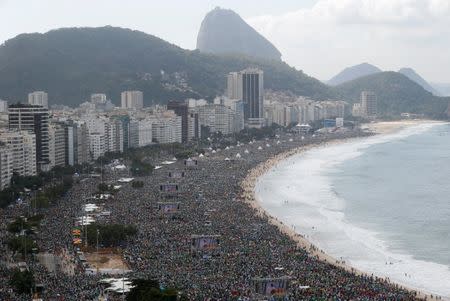 FILE PHOTO: Pilgrims attend as Pope Francis celebrates mass at Copacabana Beach in Rio de Janeiro, Brazil July 28, 2013. REUTERS/Stefano Rellandini/File photo