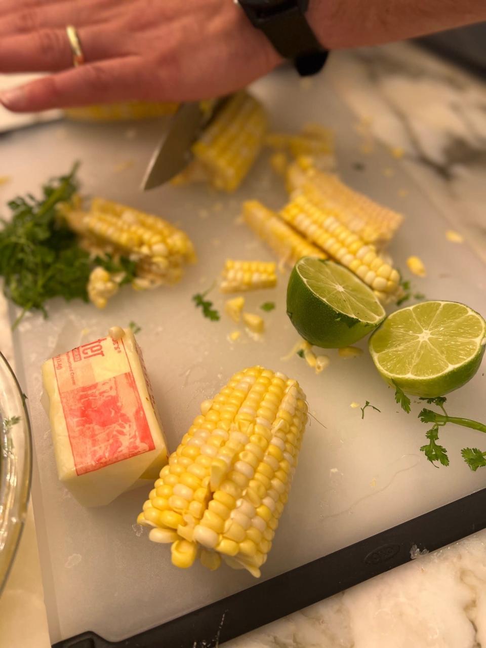 Corn and butter on a cutting board