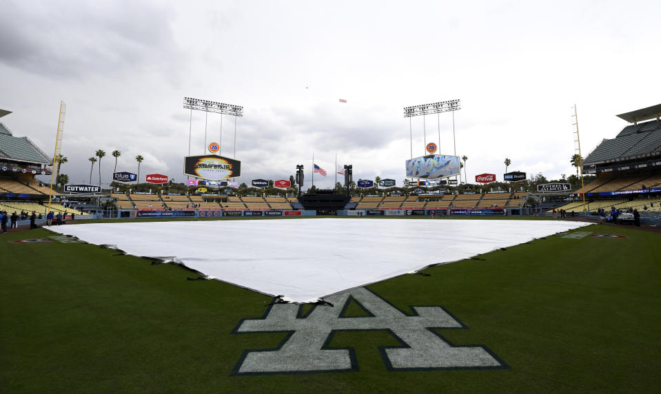 Los Angeles, CA - March 30:  The tarp back on the field as rain starts to fall prior to a Opening Day baseball game between the Los Angeles Dodgers and the Arizona Diamondbacks at Dodger Stadium in Los Angeles on Thursday, March 30, 2023. (Photo by Keith Birmingham/MediaNews Group/Pasadena Star-News via Getty Images)