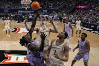 Kansas State forward Arthur Kaluma, left, competes for a rebound with Texas guard Chendall Weaver, center, and forward Dylan Disu (1) during the second half of an NCAA college basketball game Wednesday, March 13, 2024, in Kansas City, Mo. Kansas State won 78-74. (AP Photo/Charlie Riedel)