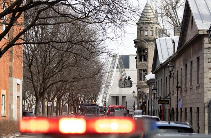 Canadian investigators inspect a heritage building before the search for seven unaccounted people after a fire in Montreal