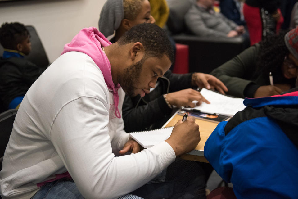 Omari Spellman writes a poem at his poetry workshop in Atlanta. (Kat Goduco Photography)