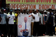 Supporters of the runner-up in Democratic Republic of Congo's presidential election, Martin Fayulu hold a sign before a political rally in Kinshasa, Democratic Republic of Congo, January 11, 2019. REUTERS/Baz Ratner