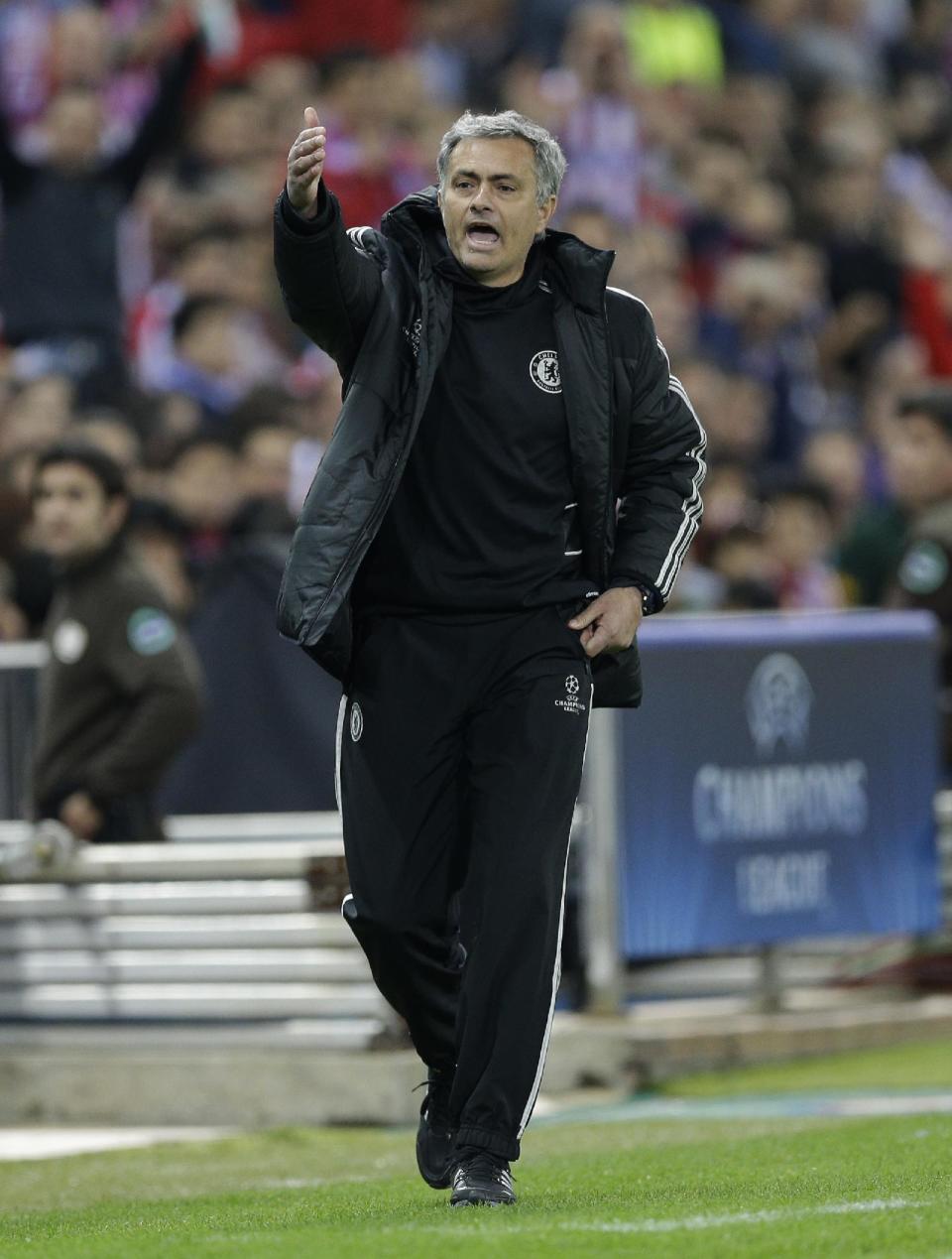 Chelsea's manager Jose Mourinho gestures to his team as he watches from the technical area during the Champions League semifinal first leg soccer match between Atletico Madrid and Chelsea at the Vicente Calderon stadium in Madrid, Spain, Tuesday, April 22, 2014 .(AP Photo/Paul White)