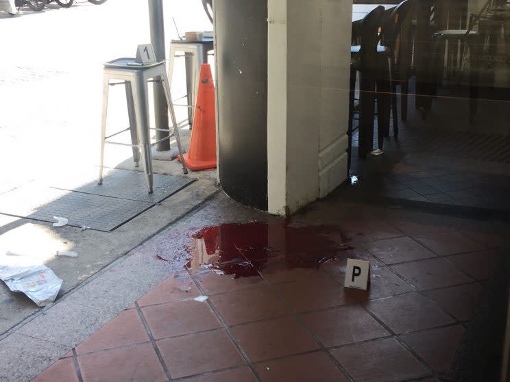 The pool of blood outside A Poke Theory. Photo: Yahoo News Singapore