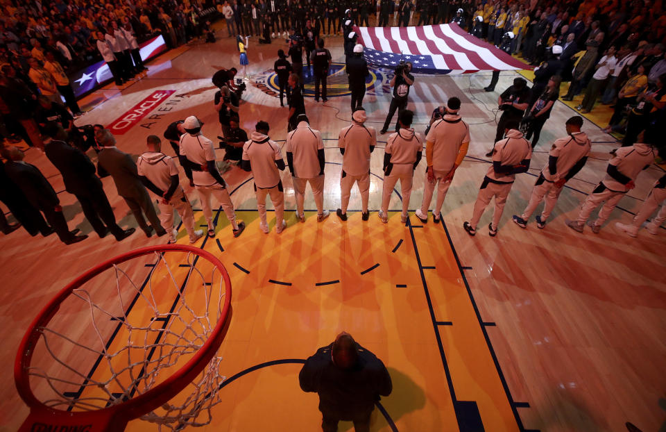 Players listen to the national anthem before Game 1 of the NBA Finals between the Golden State Warriors and Cleveland Cavaliers. (AP)