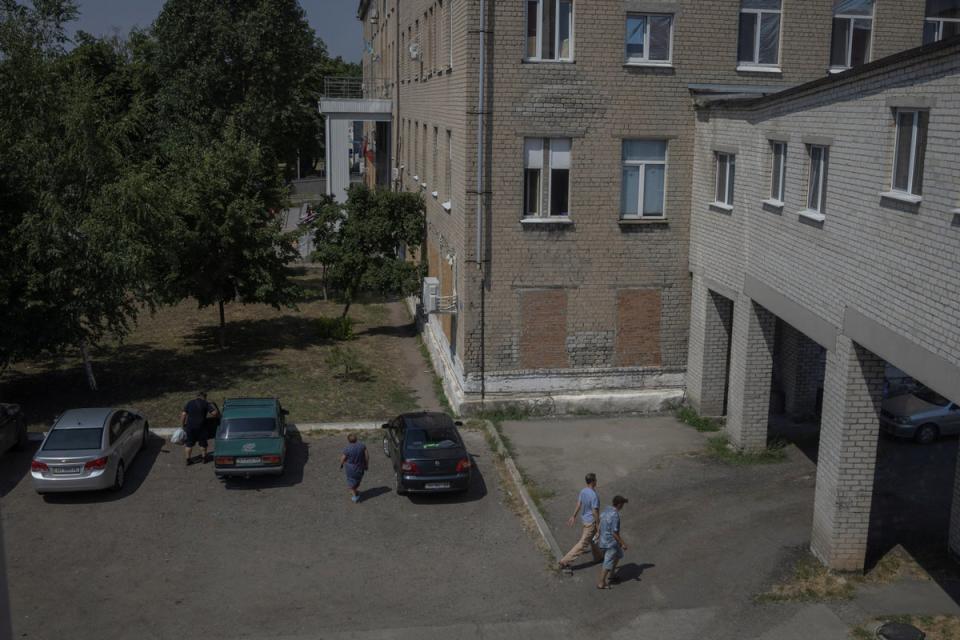 People walk in front of Pokrovsk maternity hospital (Reuters)