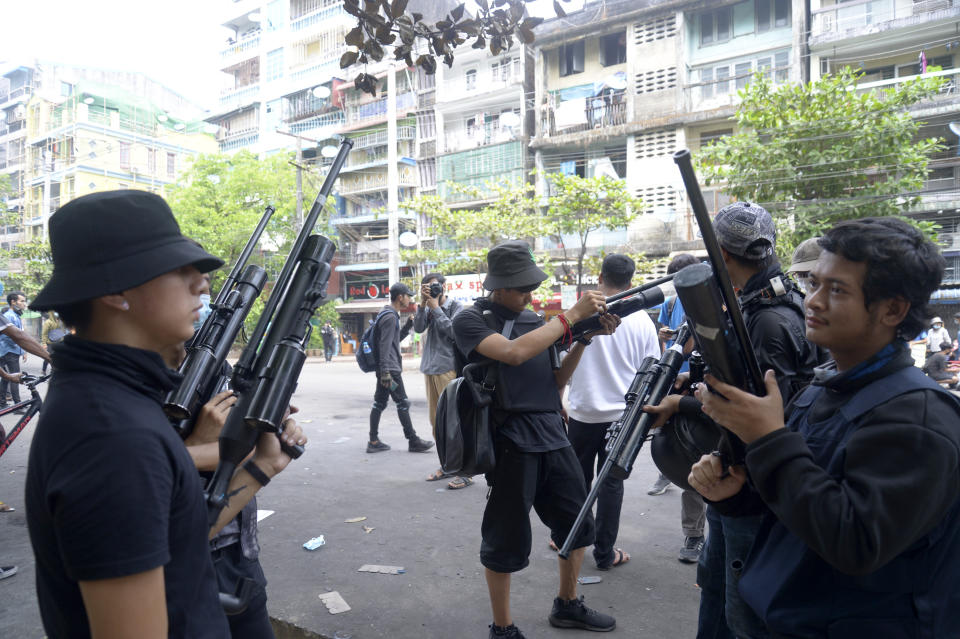 Anti-coup protesters stand guard with homemade air rifle during a protest in Yangon, Myanmar, Saturday, April 3, 2021. Threats of lethal violence and arrests of protesters have failed to suppress daily demonstrations across Myanmar demanding the military step down and reinstate the democratically elected government.(AP Photo)