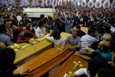 Relatives of victims react to coffins arriving to the Coptic church that was bombed on Sunday in Tanta, Egypt, April 9, 2017. REUTERS/Mohamed Abd El Ghany