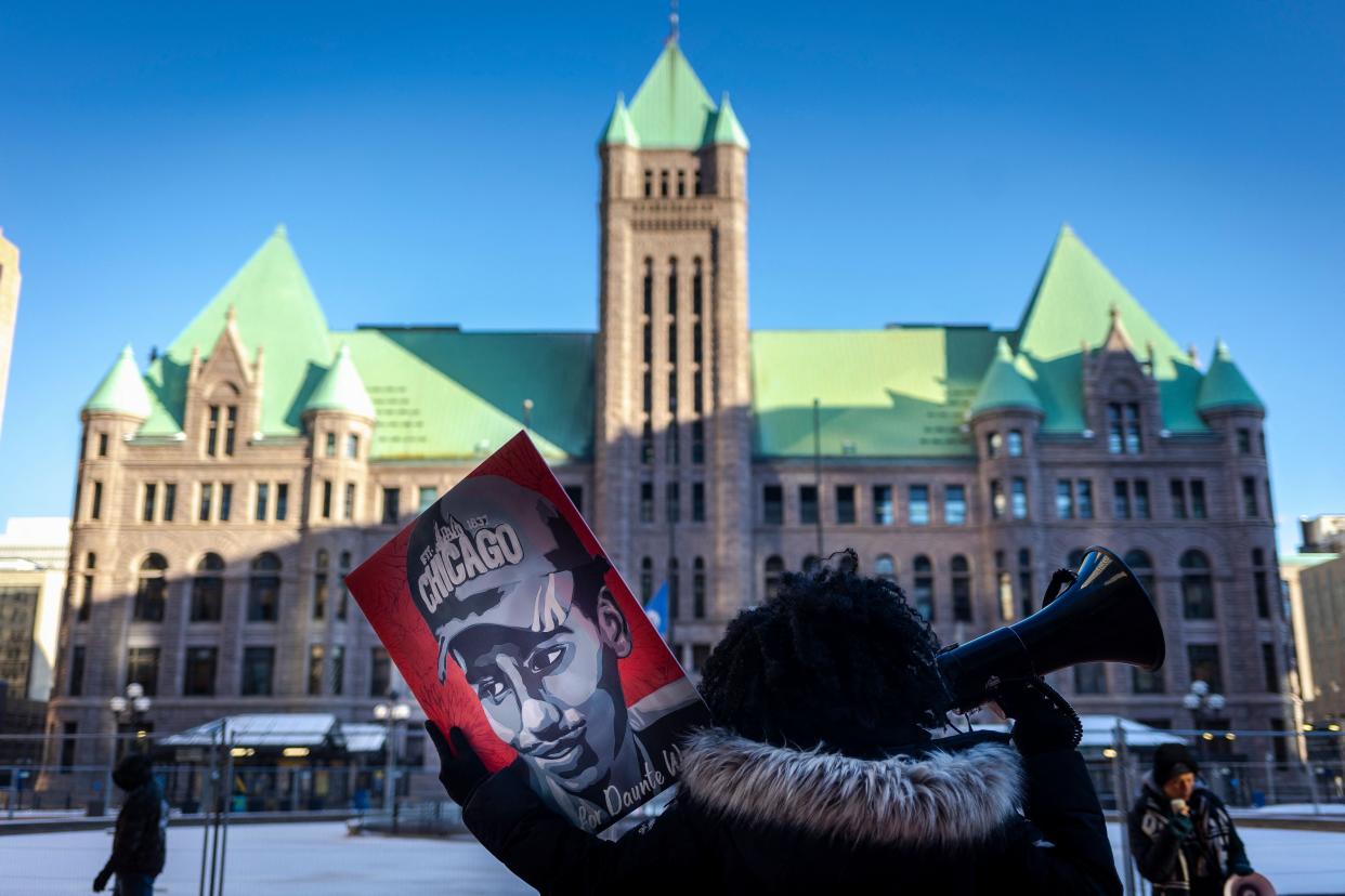 Ashley Dorelus demonstrates outside the Hennepin County Government Center in Minneapolis, Minn. on Dec. 23, 2021, during jury deliberations in the trial of former police officer Kim Potter. Potter, 49, is charged with first-degree manslaughter over the fatal shooting of Daunte Wright, 20, in Brooklyn Center, a suburb of Minneapolis, on April 11, 2021. She claims the shooting was an accident, saying she mistakenly grabbed her gun instead of her Taser.