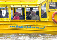 The Queen looks to be reserving judgement as she rides the 'Yellow DuckMarine' as it enters the waters in Liverpool's harbour