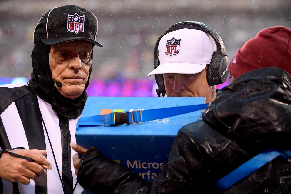 EAST RUTHERFORD, NJ - DECEMBER 16:  Referee Shawn Hochuli #83 and field judge Tom Hill #97 look at a replay during the game between the New York Giants and the Tennessee Titans at MetLife Stadium on December 16, 2018 in East Rutherford, New Jersey.  (Photo by Steven Ryan/Getty Images)