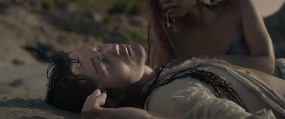 Prince Eric unconscious on the beach