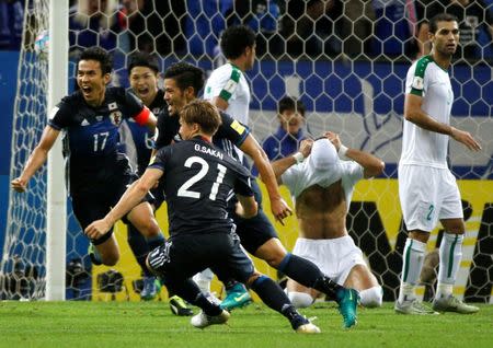 REFILE-CAPTION CLARIFICATION Football Soccer - Japan v Iraq - World Cup 2018 Qualifier - Saitama Stadium 2002, Saitama, Japan - 6/10/16. Japan's Hotaru Yamaguchi and teammates celebrate after scoring the second goal for Japan against Iraq. REUTERS/Issei Kato