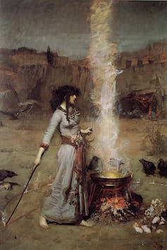 A painting of a woman with dark hair in a long dress stood by a steaming cauldron.