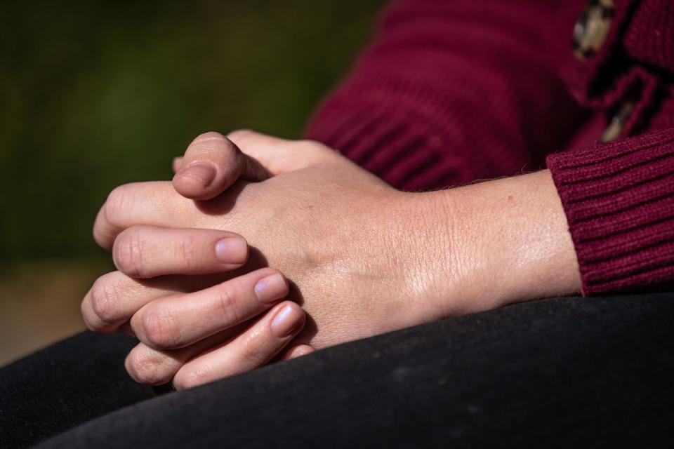 The clasped hands of Jane Doe, a woman who says she was groomed as a teen into sexual activity with an adult youth worship leader at Grace Church Noblesville. She came forward with allegations of the decade-old events last year after watching the man rise in leadership at the church.