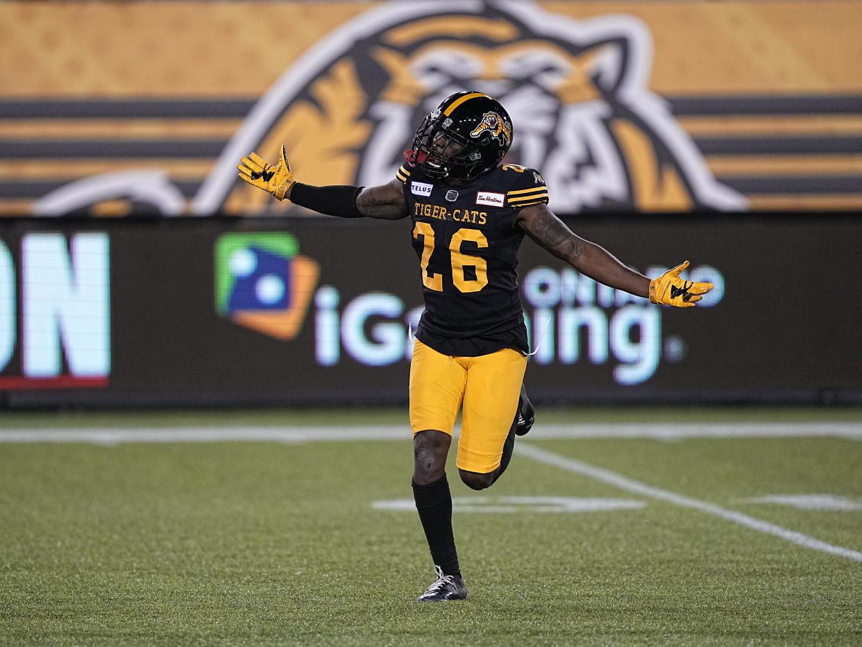 Hamilton Tiger-Cats player Cariel Brooks celebrates in front of an iGaming Ontario logo at Tim Hortons Field. Wall Street analysts predict Ontario's legally-overhauled sports betting market will be dominated at the onset by former grey market bookies. (Photo by John E. Sokolowski/Getty Images)