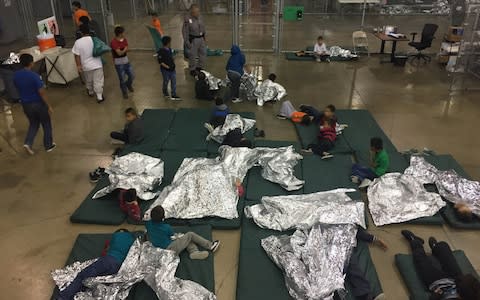 A view of inside a Texas detention facility shows children sleeping under foil sheets - Credit: Courtesy CBP/Handout via REUTERS