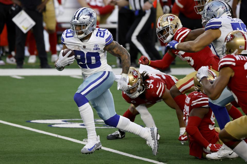 Dallas Cowboys running back Tony Pollard (20) breaks through San Francisco 49ers tackle attempts on his way to the end zone for a touchdown in the second half of an NFL football game in Arlington, Texas, Sunday, Dec. 20, 2020. (AP Photo/Ron Jenkins)