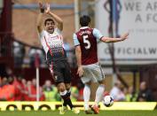 West Ham United's James Tomkins (R) handles the ball while challenging Liverpool's Luis Suarez to concede a penalty during their English Premier League soccer match at Upton Park in London April 6, 2014. REUTERS/Dylan Martinez (BRITAIN - Tags: SPORT SOCCER) FOR EDITORIAL USE ONLY. NOT FOR SALE FOR MARKETING OR ADVERTISING CAMPAIGNS. NO USE WITH UNAUTHORIZED AUDIO, VIDEO, DATA, FIXTURE LISTS, CLUB/LEAGUE LOGOS OR "LIVE" SERVICES. ONLINE IN-MATCH USE LIMITED TO 45 IMAGES, NO VIDEO EMULATION. NO USE IN BETTING, GAMES OR SINGLE CLUB/LEAGUE/PLAYER PUBLICATIONS