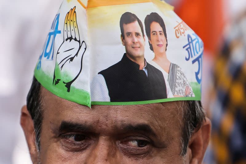 A supporter wears a cap with the picture of Rahul Gandhi, a senior leader of India's main opposition Congress party and his sister Priyanka Gandhi Vadra, in Raebareli