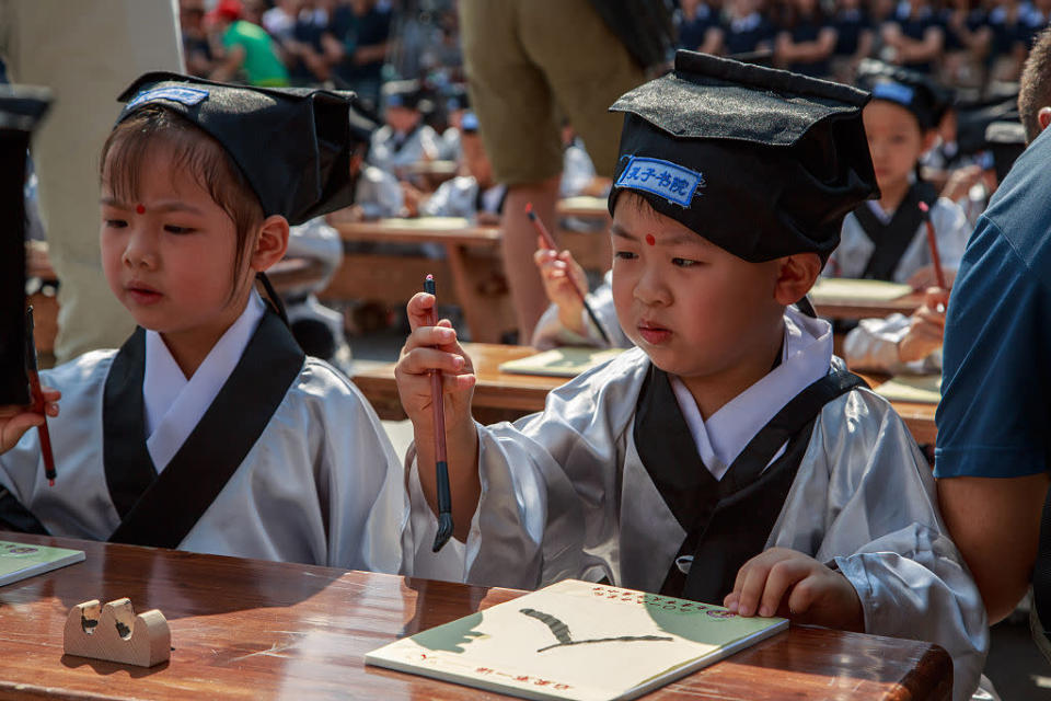 <p>168 pupils of Fuzimiao Primary School attended a Confucian ceremony at the Confucius temple to start the new term in Nanjing, Jiangsu Province of China. (VCG/VCG via Getty Images)<br></p>