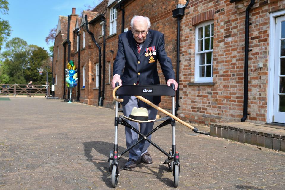 British World War II veteran Captain Tom Moore, 99, poses with his walking frame doing a lap of his garden in the village of Marston Moretaine, 50 miles north of London, on April 16, 2020. - A 99-year-old British World War II veteran Captain Tom Moore on April 16 completed 100 laps of his garden in a fundraising challenge for healthcare staff that has 