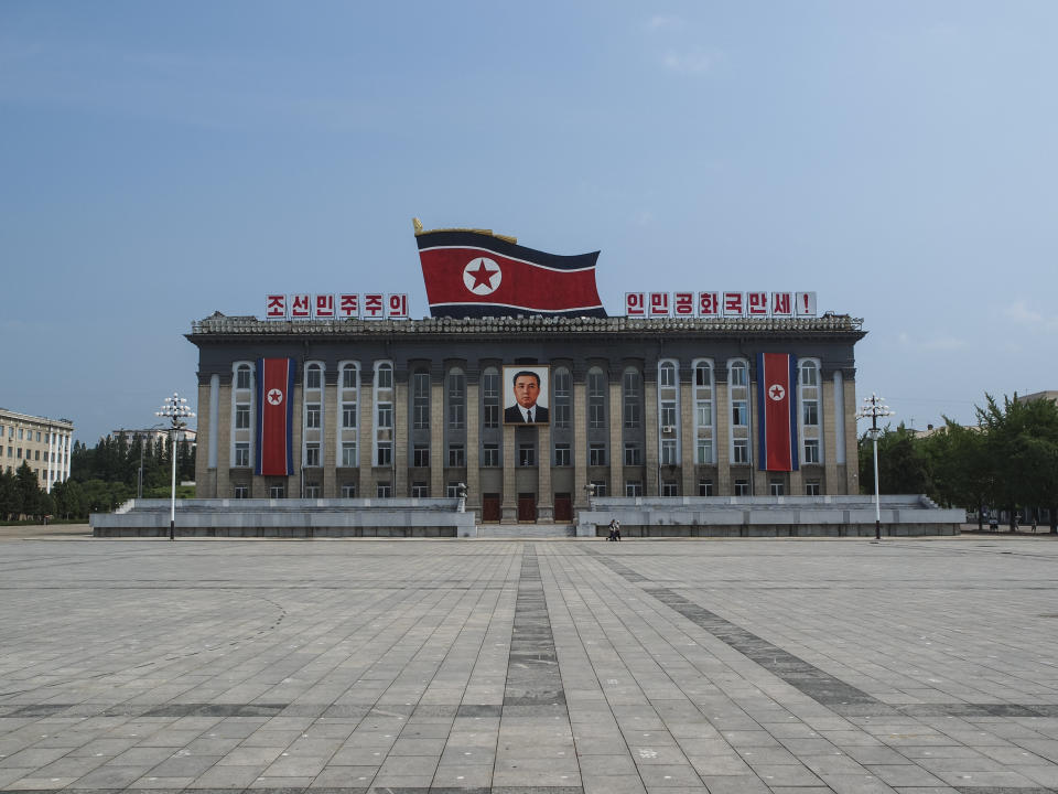 Pyongyang, North Korea – July 27, 2011: The Kim Il-Sung Square is named after the founding leader of the DPRK. It opened in August 1954. The square is located on the west bank of the Taedong River, directly opposite of the Juche Tower. The square is the common gathering place for North Korea's massive military parades. The marks on the ground serve to position the soldiers and units during these parades. 