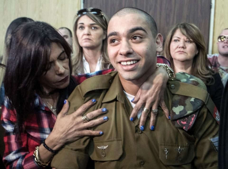 Elor Azariais embraced by his mother after being sentenced in a military court last year: AFP/Getty Images