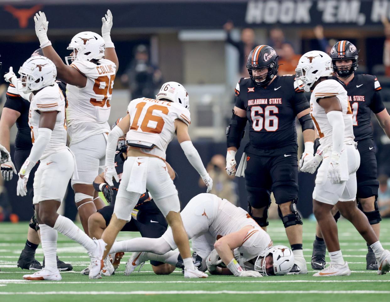 Texas' Ethan Burke (91) recovers a fumble in the first half of the Big 12 Football Championship game between the Oklahoma State University Cowboys and the Texas Longhorns at the AT&T Stadium in Arlington, Texas, Saturday, Dec. 2, 2023.