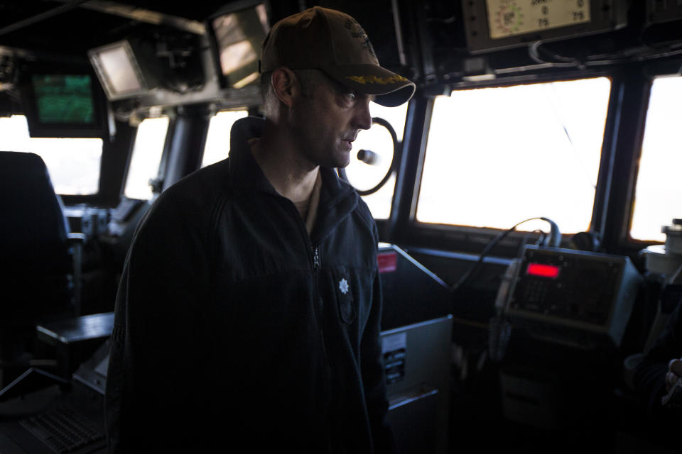 Cmdr. Hunter Washburn stands on the bridge of the USS Gravely on Tuesday, March 14, 2023 while docked at Norfolk Naval Station in Norfolk, Va. Washburn says that chaplains need to be "eyeball to eyeball (with sailors), to check in and see how they're doing." (AP Photo/John C. Clark)