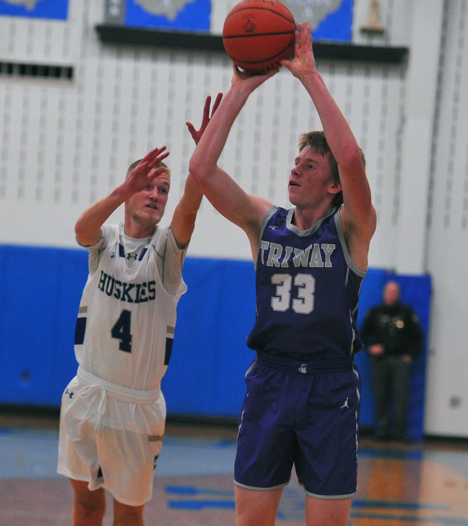 Triway's Drew Bishko shoots for 2 while Northwestern's Easton Thomas attempts to block.