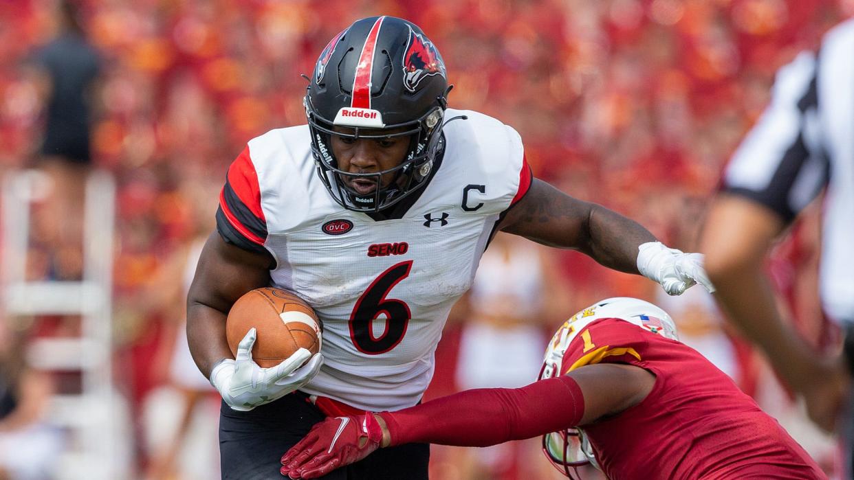 Former Peoria High School running back Geno Hess, in a game with Southeast Missouri State, has been named Ohio Valley Conference Player of the Year and finished fifth in voting for Walter Payton award.