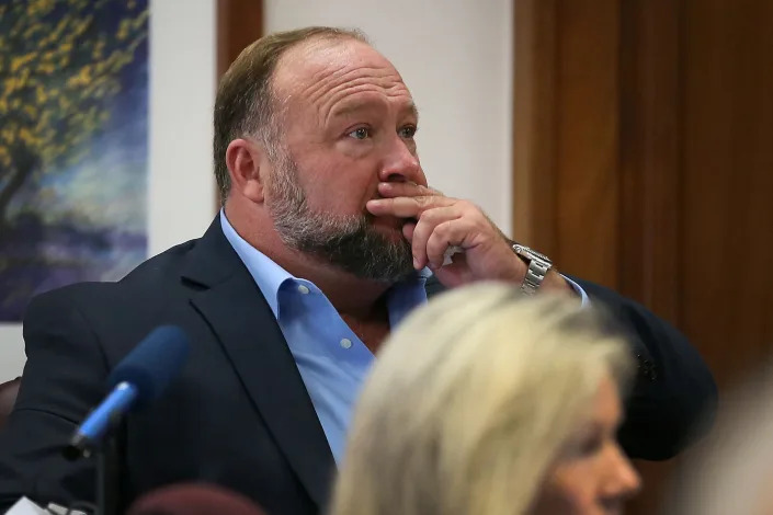 Alex Jones attempts to answer questions about his text messages at his defamation trial in Austin, Texas, on Wednesday. (Briana Sanchez/Pool via Reuters)