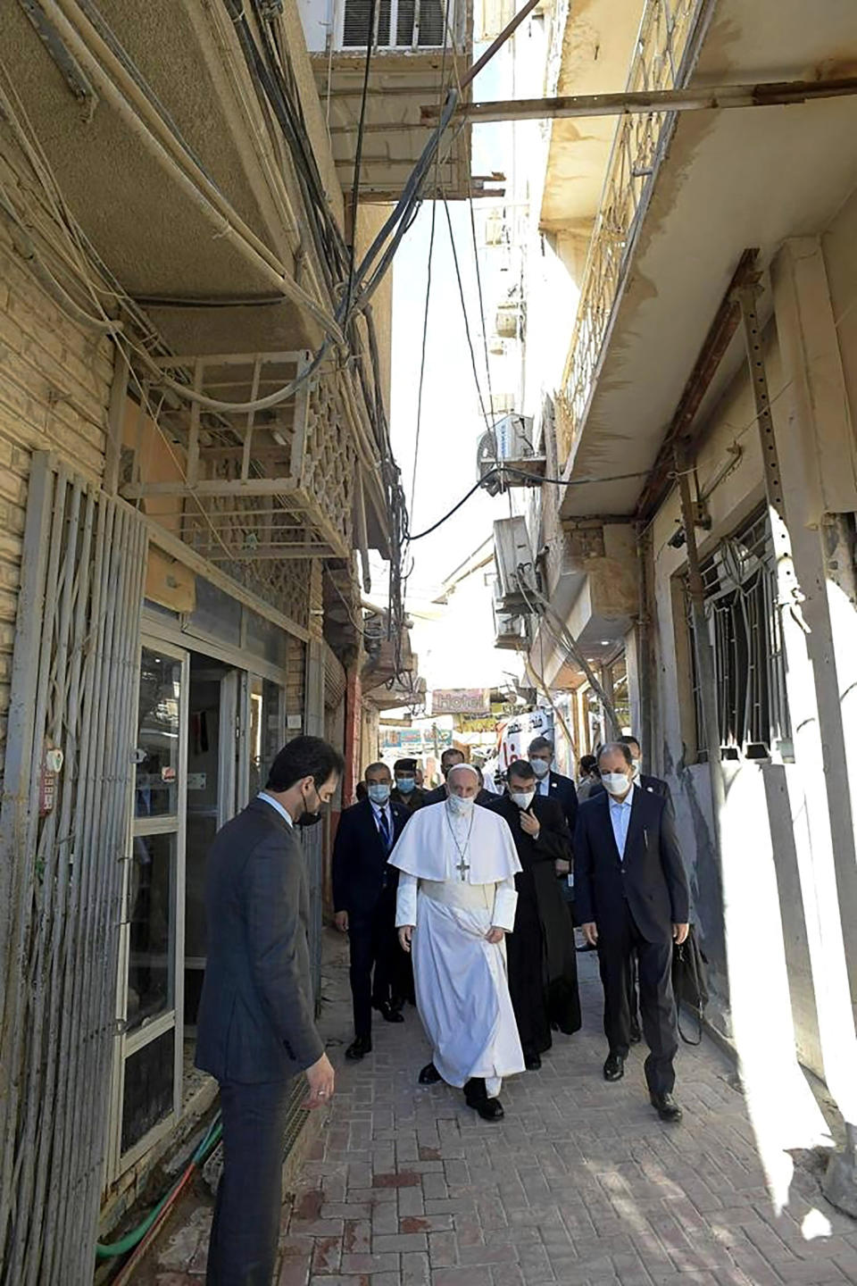 In this photo released by the Grand Ayatollah Ali al-Sistani Office, Pope Francis, center, leaves after his meeting with Shiite Muslim leader, Grand Ayatollah Ali al-Sistani in Najaf, Iraq, Saturday, March 6, 2021. Pope Francis arrived in Iraq on Friday to urge the country's dwindling number of Christians to stay put and help rebuild the country after years of war and persecution, brushing aside the coronavirus pandemic and security concerns to make his first-ever papal visit. ( The Grand Ayatollah Ali al-Sistani Office s via AP)