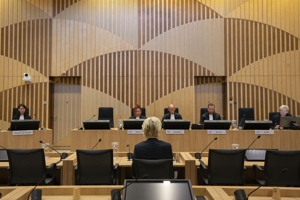 Firebrand anti-Islam lawmaker Geert Wilders listened as presiding judge Verbeek, center, delivered the court's verdict against a former Pakistan cricketer accused of incitement to kill, at the high security court building near Schiphol airport, Monday, Sept. 11, 2023. The suspect, identified by Wilders as Khalid Latif, is accused of offering a bounty of some 21,000 euros ($23,000) to anybody who killed Wilders. Prosecutors haven't named Latif. However, in a statement they say a video posted online in 2018 shows a famous Pakistan cricketer offering a bounty for killing Wilders. (AP Photo/Peter Dejong)