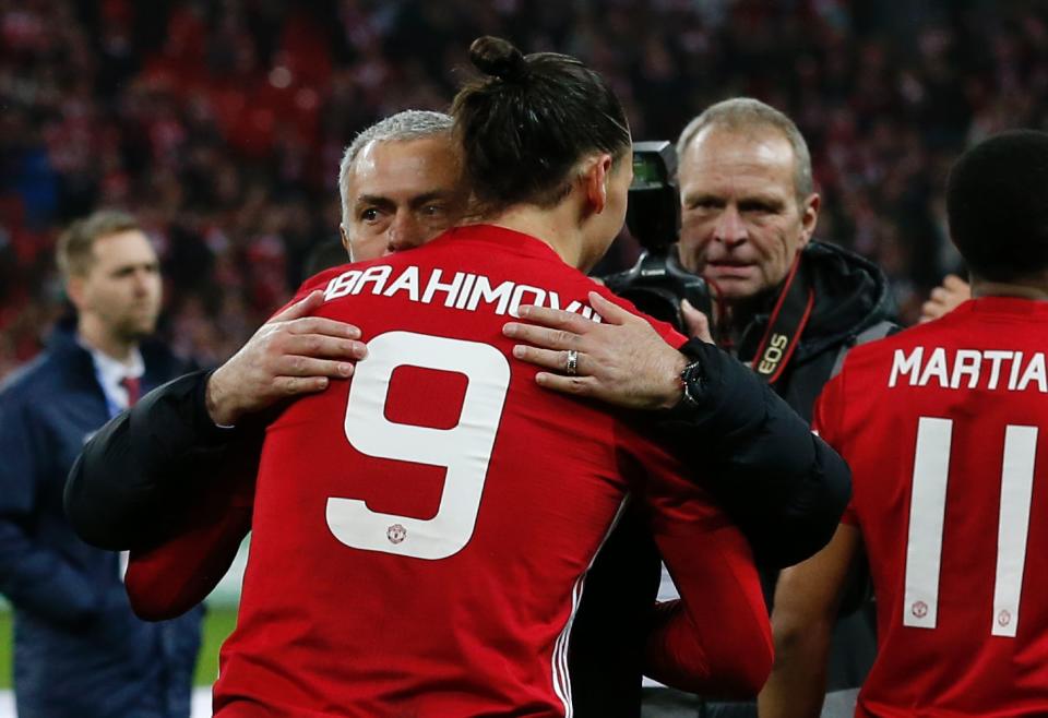 Manchester United's Swedish striker Zlatan Ibrahimovic embraces Manchester United's Portuguese manager Jose Mourinho as players celebrate on the pitch after their victory in the English League Cup final football match between Manchester United and Southampton at Wembley stadium in north London on February 26, 2017. Zlatan Ibrahimovic sealed the first major silverware of Jose Mourinho's Manchester United reign and broke Southampton's hearts as the Swedish star's late goal clinched a dramatic 3-2 victory in Sunday's League Cup final. / AFP / Ian KINGTON / RESTRICTED TO EDITORIAL USE. No use with unauthorized audio, video, data, fixture lists, club/league logos or 'live' services. Online in-match use limited to 75 images, no video emulation. No use in betting, games or single club/league/player publications.  /         (Photo credit should read IAN KINGTON/AFP via Getty Images)