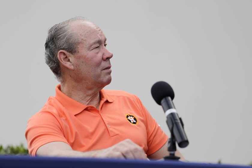 Houston Astros owner Jim Crane pauses during a news conference.