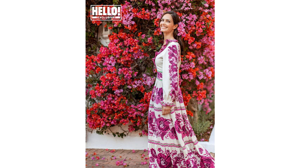 Veronica Schmidt in floral dress by pink and red floral wall outside Marbella home