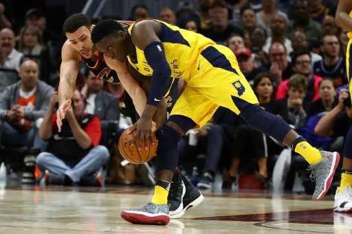 Victor Oladipo (R) of the Indiana Pacers battles for the ball with Larry Nance Jr. of the Cleveland Cavaliers