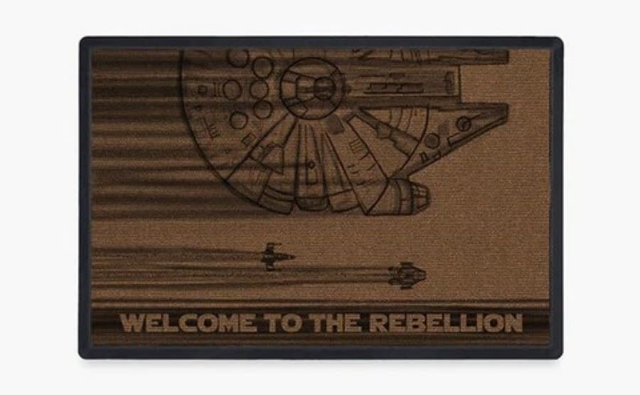 A doormat that says Welcome to the Rebellion with the Millenium Falcon on it